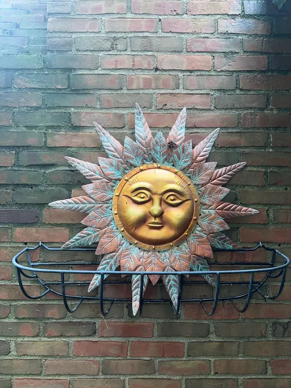 Large metal hanging planter and metal sun
