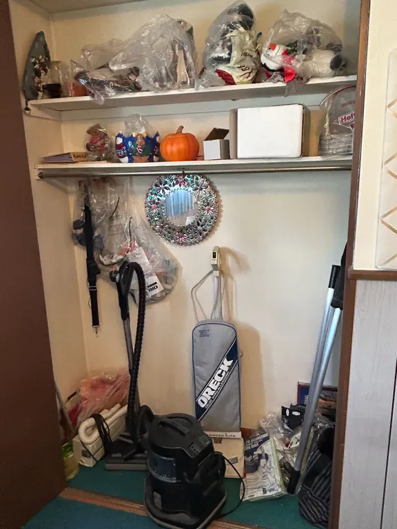 Closet Contents: Oreck XL Upright Vacuum, Rainbow Canister Vacuum, Seasonal Decor