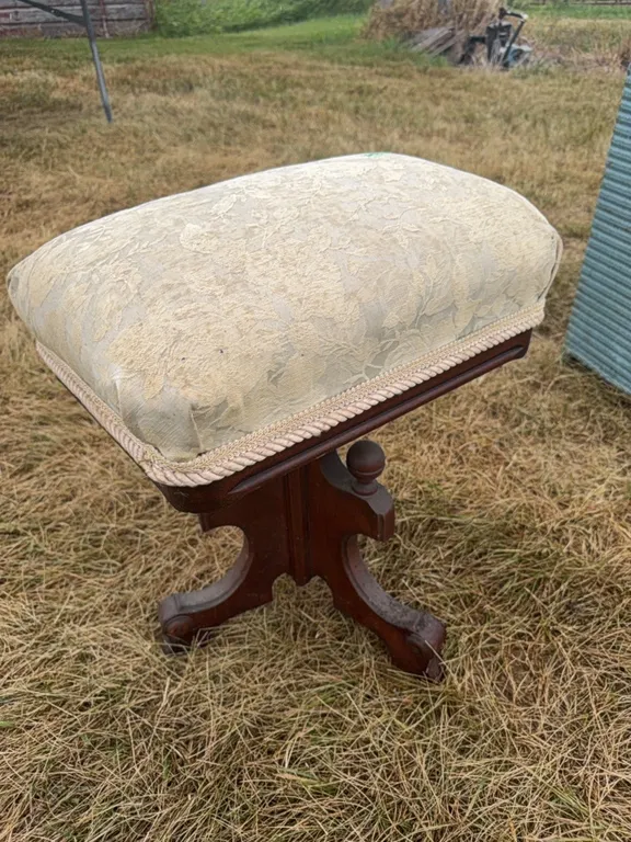 antique wooden stool with puffy seat