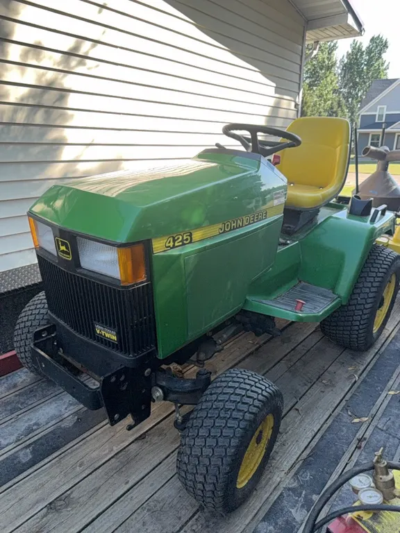 John Deere model 425 garden tractor, newer model, all wheel steer, only 252 hours since new, includes rear tine tiller, mower deck (60 inch deck) has