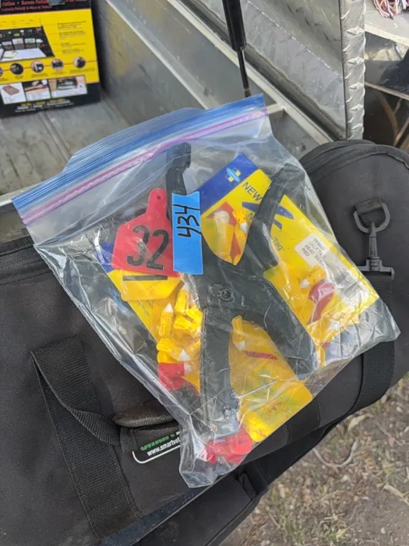 Livestock ear tags with tool
