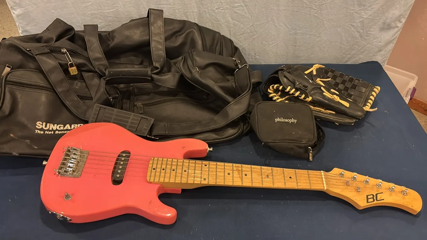 Travel bag, baseball glove, and electric guitar
