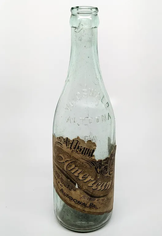 PRE PROHIBITION 12 OZ PAPER LABEL BEER BOTTLE V.A. OSWALD AMERICAN EXPORT BEER ALTOONA PENNSYLVANIA