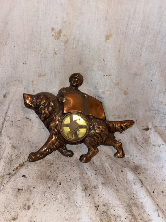 Brass dog and person