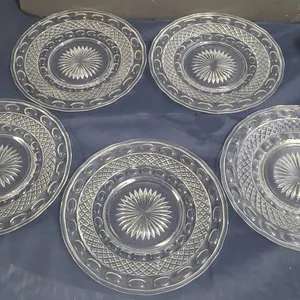 Five Clear Pressed Glass Plates with Geometric and Sunburst Patterns, Circular Motifs Throughout