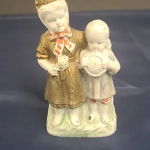 Porcelain Figurine of Two Children, Painted Accents, Includes Handwritten Notes in Base Compartment