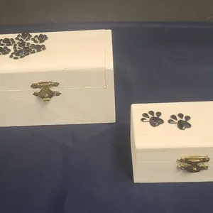 Two White Painted Wooden Boxes with Black Paw Print Decorations and Brass-Colored Hardware Closures