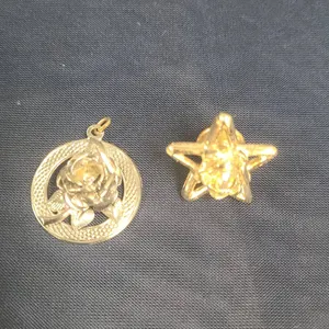 Two Gold Tone Jewelry Pieces: Rose Motif Circular Pendant and Star Lapel Pin with Crystal Centerpiec