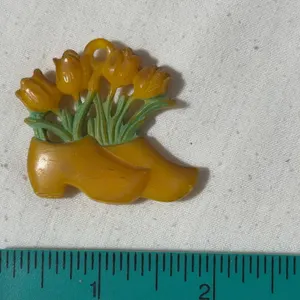 Vintage butterscotch-colored Dutch clogs and tulips charm/pendant