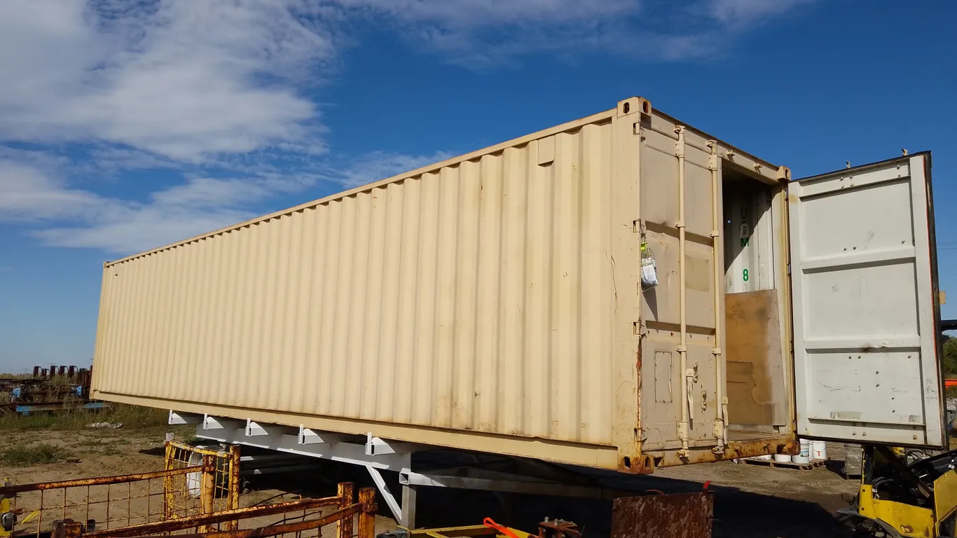 40' long x 8' wide x 8'5" tall Sea Can Shipping Container with shelving on both walls. Loader on site- just bring a big truck/ flat deck!