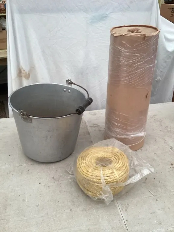 Metal bucket, approximately 11" diameter x 9" high, roll of paper, poly rope 1/4" x 150'