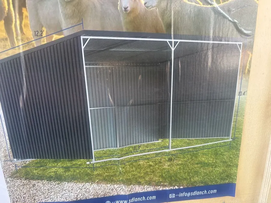 SDLANCH. Galvanized metal livestock shed. Unassembled. See pictures for details. 8 1/2' high at the back, 10' 4" high at the front. 11' deep, 19’2” wi