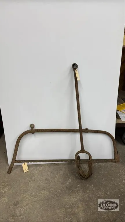 MANUAL POST HOLE AUGER WITH A RUSTY BOW SAW