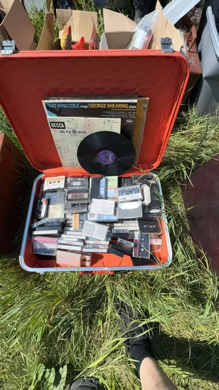 Red Suitcase With Vinyl Records and Cassette Tapes