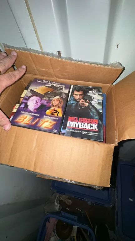 Box of DVDs and VHS Tapes