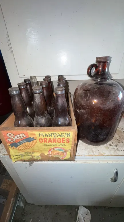 Sun Mandarin Oranges Crate With Vintage Glass Bottles and Jug