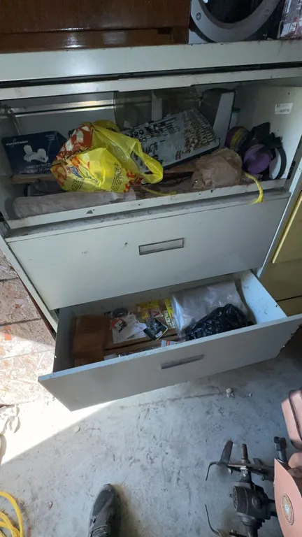 Garage Cabinet Contents with Stereo, Bottles, Tools, and Hardware