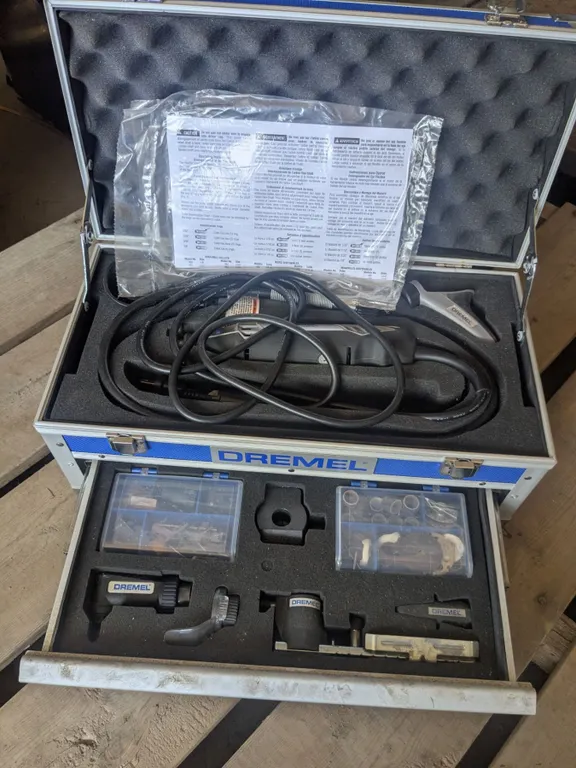 Dremel with attachments in storage case