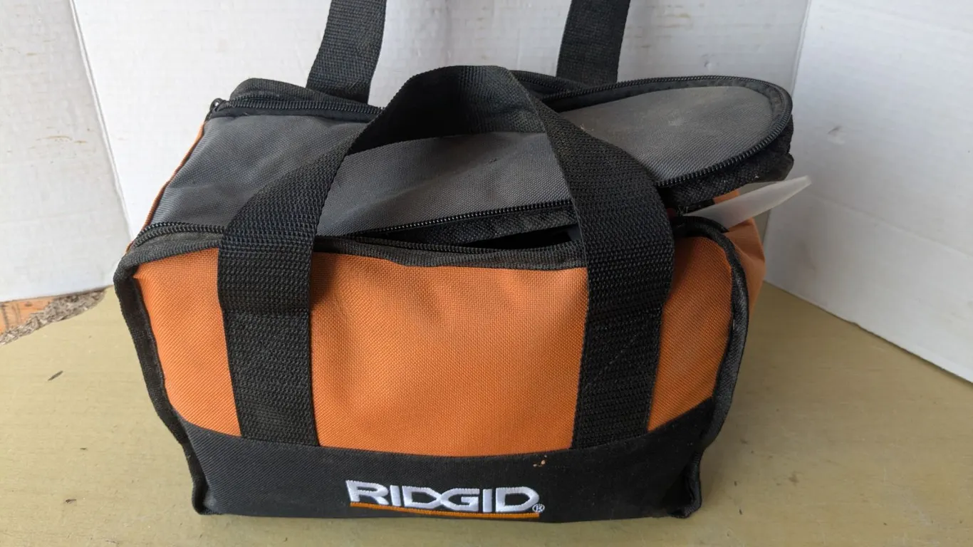 Small rigid toolbag with assorted tools and hardware