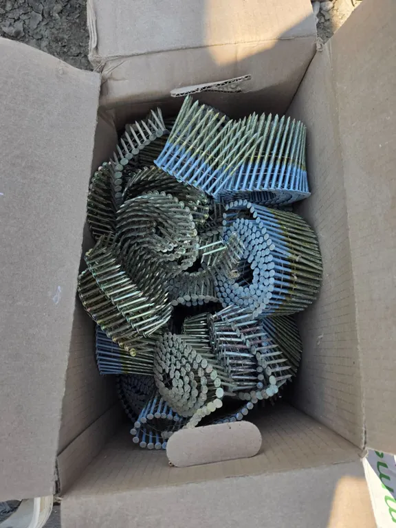 Box full of coiled nails- sizes vary