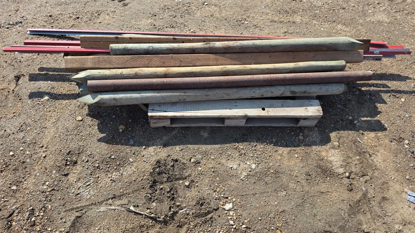 Pallet of treated wooden posts and trim- posts are 6ft L