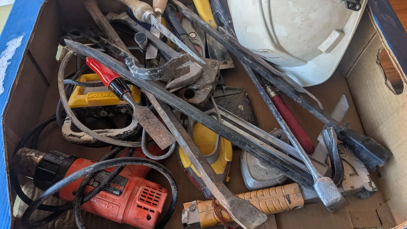 Box of tools, hardhat, heat gun, etc