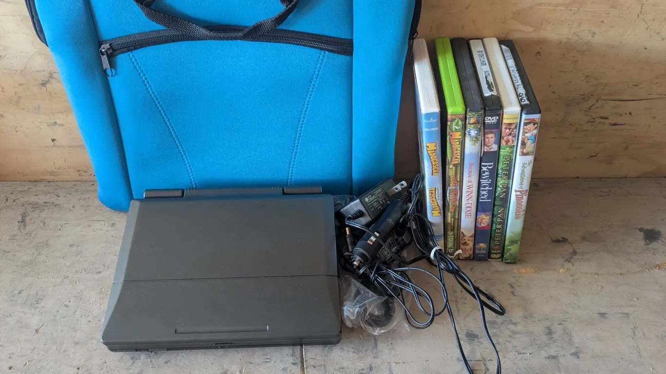 Portable DVD Player w/ (6) DVDs and Carry Bag – Not Tested