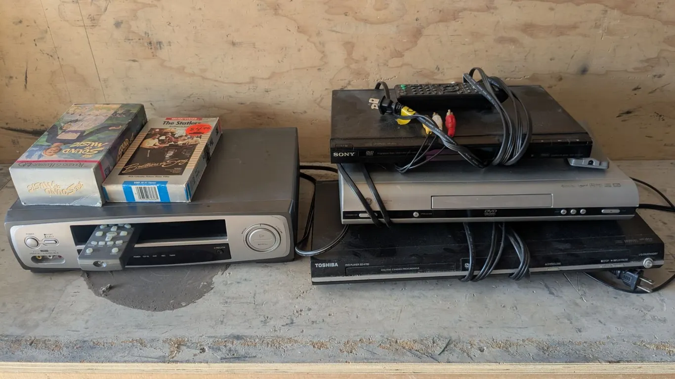 (3) DVD Players, (2) VHS Player w/ (2) VHS Movies – Not Tested