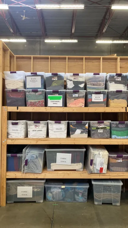 GROUP OF 26 PLASTIC STORAGE BINS FULL OF ASSORTED FABRIC MATERIAL