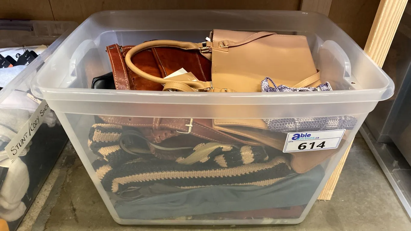 ONE PLASTIC STORAGE BIN OF ASSORTED PURSES