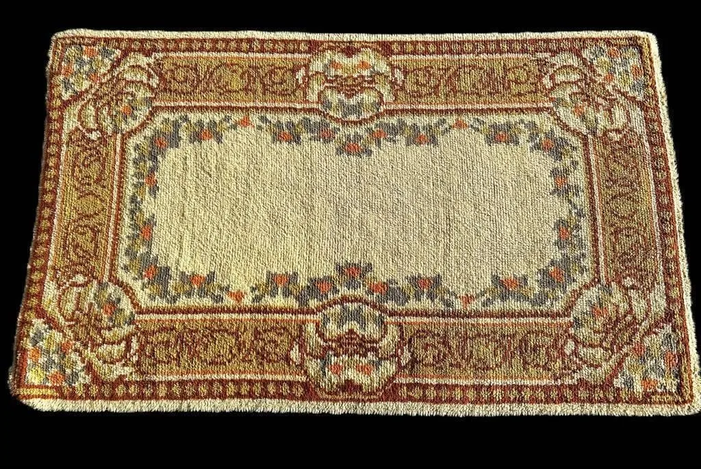 ORANGE, CREAM, & BROWN AREA RUG W/ FLORAL PATTERN