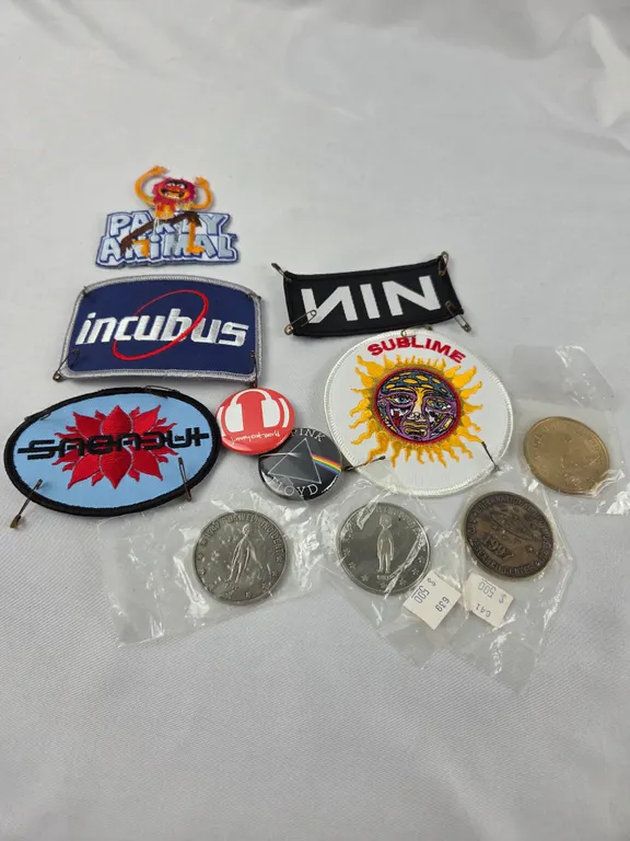 Assortment of patches, pins, and tokens