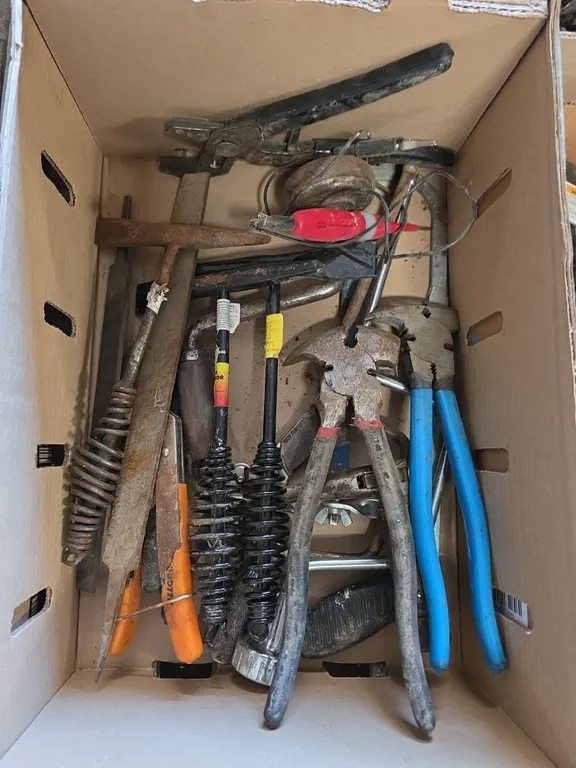 Box of chipping hammers, fence pliers and files