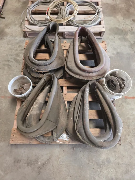 Pallet of 8 horse collars, pale of horseshoes and steel wedges