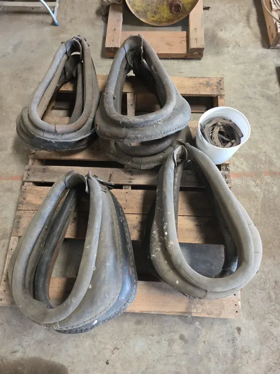 Pallet of 8 horse collars and pale of horseshoes