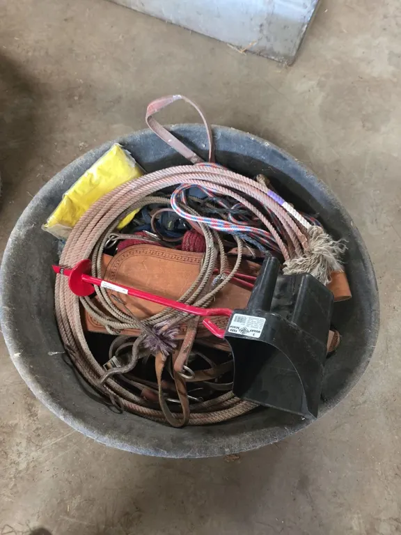 Rubber feed pan with assorted tack, lariats and a feed scoop