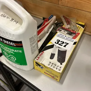 3 - NEW/UNUSED STRAPS, GREASE GUN, NIPPLES & A JUG OF METHYL HYDRATE