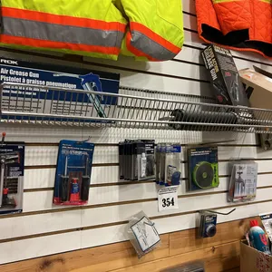 NEW/UNUSED ITEMS ON WALL BETWEEN THE ORANGE RIBBONS