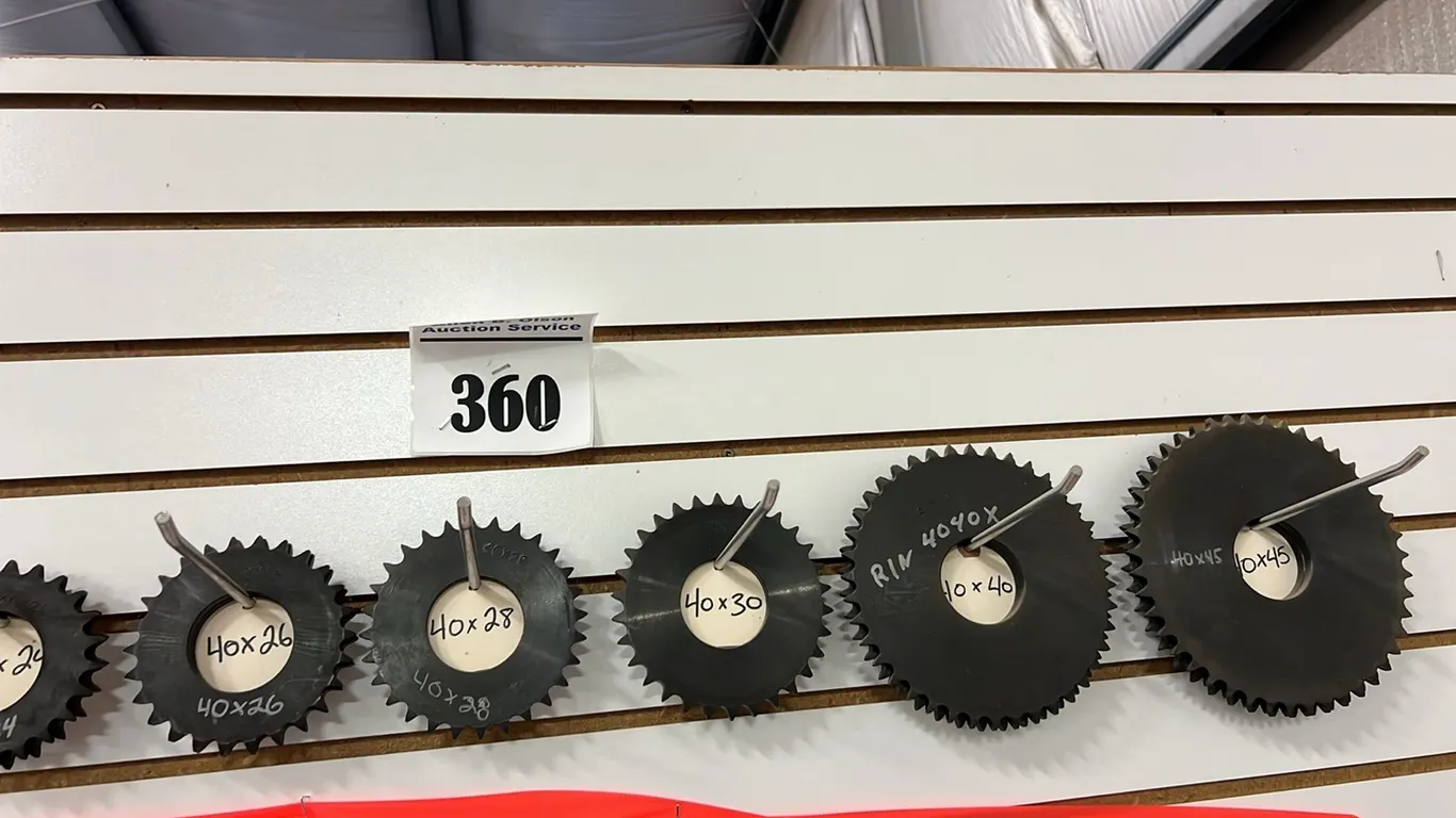 LARGE AMOUNT OF NEW/UNUSED SPROCKETS ON WALL - 16 SIZES FROM 40X11 TO 40X45