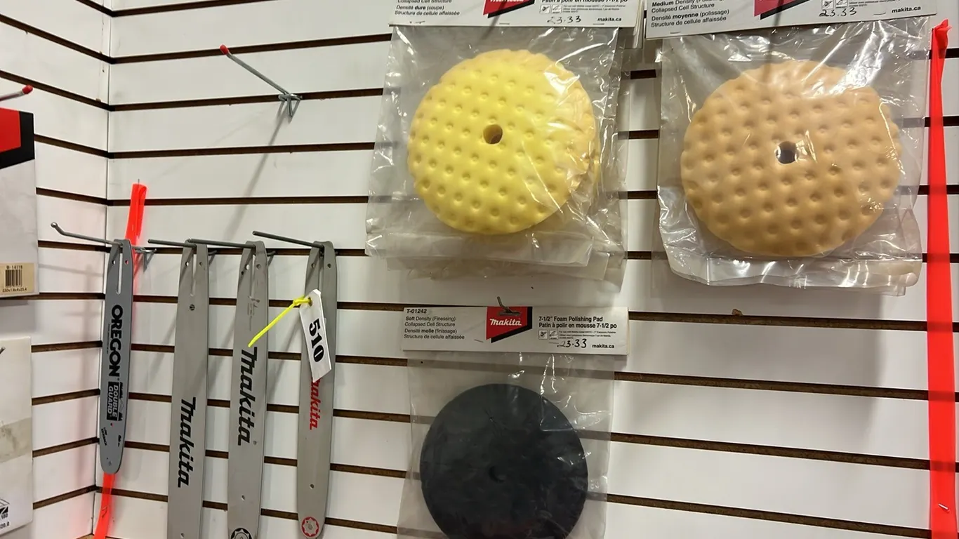 ITEMS ON WALL BETWEEN RIBBONS - 4 - CHAINSAW BARS & 7 - 7 1/2" FOAM POLISHING PAD