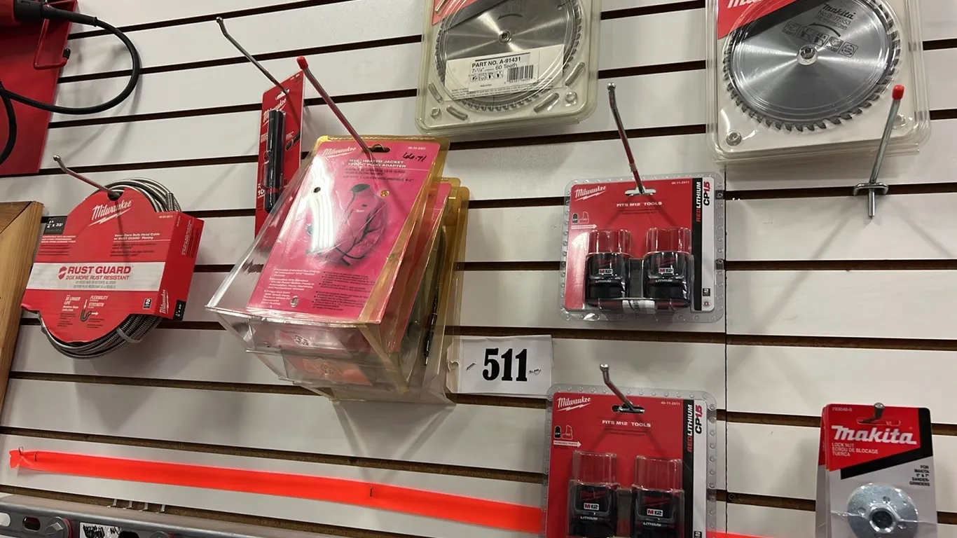 ITEMS ON WALL INCLUDING - NEW/UNUSED MILWAUKEE 1/4"X35'L BULBHEAD CABLE, NEW/UNUSED MAKITA 7 1/4" CIRCULAR SAW BLADE & MUCH MORE