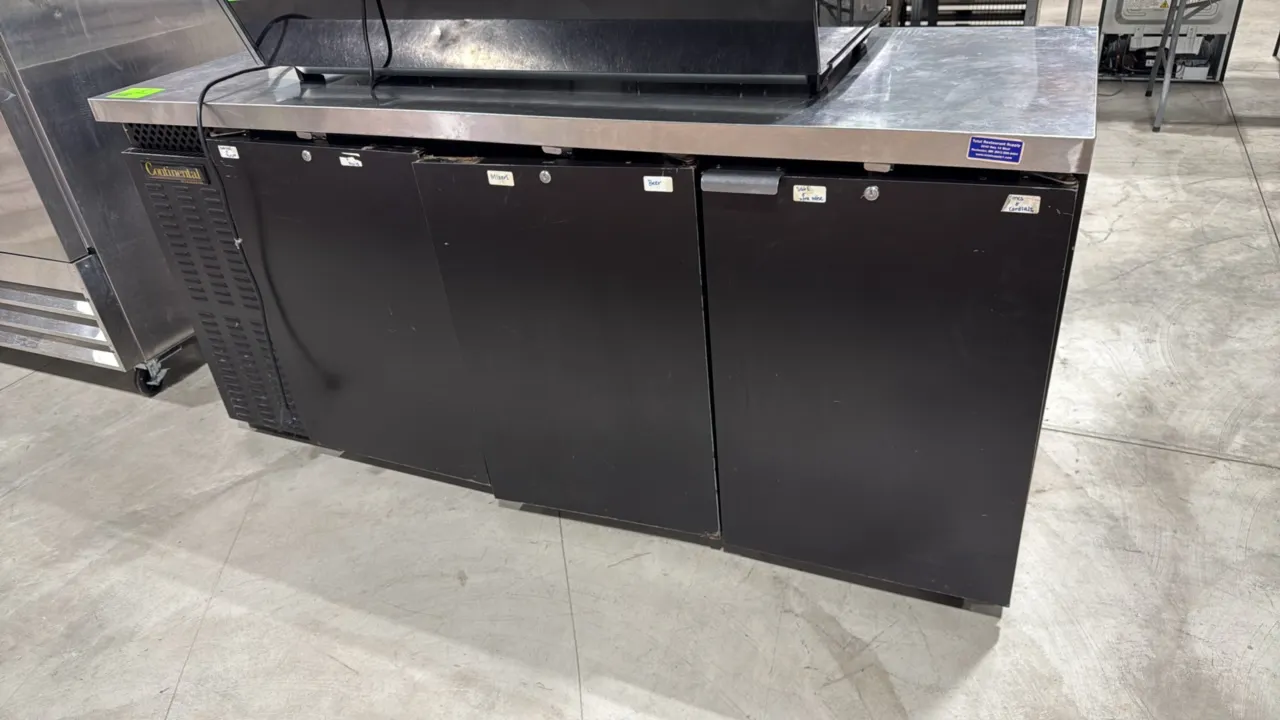 Continental BBC79 self-contained 3-door back bar refrigerator. Features a stainless steel flat top and black exterior finish. 79"W. S/N: 15131359. Ele