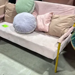 Pink upholstered loveseat. Features light pink fabric upholstery and gold-tone metal legs. Includes (5) assorted decorative throw pillows. 48"L.