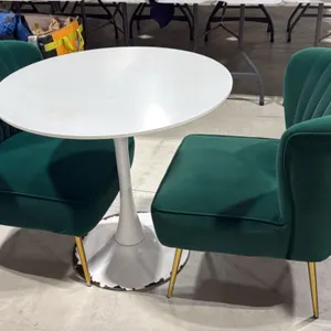 White pedestal table with (2) green upholstered chairs. Table features a 31.5" round top on a pedestal base. Chairs feature green fabric upholstery, c