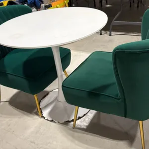 Pedestal table and chair set. Includes 31.5" round white pedestal table on a tulip base and (2) 22"W green fabric upholstered accent chairs. Chairs fe