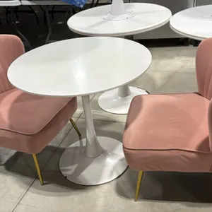 White pedestal table with (2) pink upholstered accent chairs. Includes 31.5"Dia round table on a white tulip pedestal base and (2) 22"W pink fabric ch