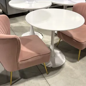 Pedestal table and chair set. Includes (1) round white pedestal table and (2) pink fabric upholstered accent chairs. Chairs feature channel-tufted bac