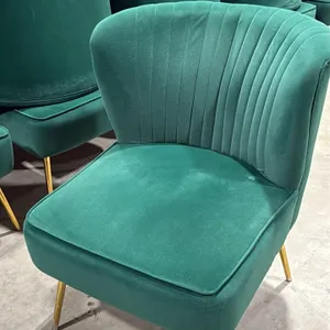 Green upholstered accent chair. Features channel-tufted backrest and cushioned seat. Mounted on tapered gold-tone metal legs. 22"W.