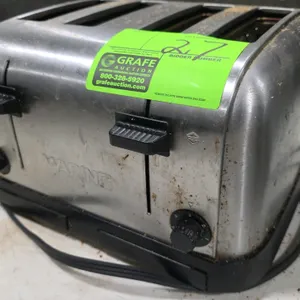 Waring 4-slice commercial toaster. Features brushed stainless steel housing, dual carriage levers, and independent browning control dials. Note: Side 
