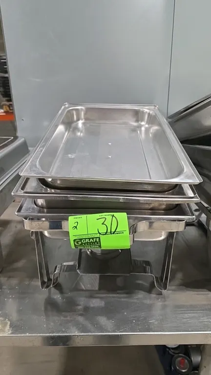 Stainless steel chafing dish sets. Each 3-piece set includes a lid with handle, pan, and stand with fuel holder tray.